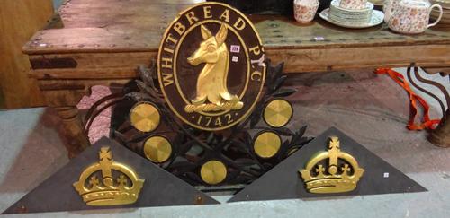 A Whitbread gilt and iron pub sign top and two gilt crown sign pediments, (3).  ROST