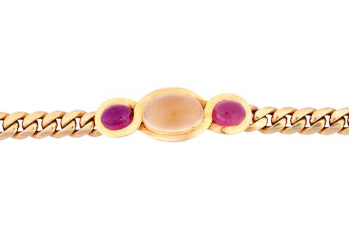 A Bvlgari gold, cabochon citrine and carbuncle garnet set bracelet, mounted with an oval cabochon citrine to the centre, between two oval carbuncle ga
