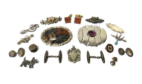 A Victorian shaped oval vary coloured granite set brooch, probably Scottish, a gold mounted oval brooch, with a shield and cross motif, detailed 9 CT,