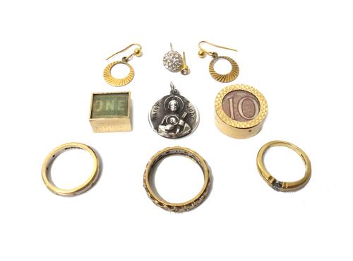 A 9ct gold ring, mounted with a circular cut diamond, a 9ct two colour gold and diamond set eternity ring, a gold and colourless gem set eternity ring