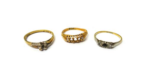 An 18ct gold ring mounted with two diamonds (three further gem stones lacking), London 1909, a gold and platinum ring, mounted with a diamond and a co