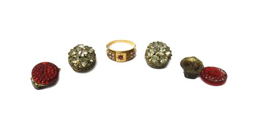 A Victorian 15ct gold, ruby and seed pearl set ring, star set with a cushion shaped ruby at the centre, between seed pearl set sides (three seed pearl