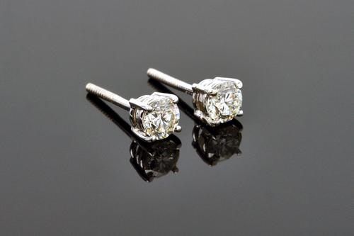 A pair of 18ct white gold and diamond set single stone earstuds, each claw set with a circular cut diamond, the backs with threaded post and butterfly