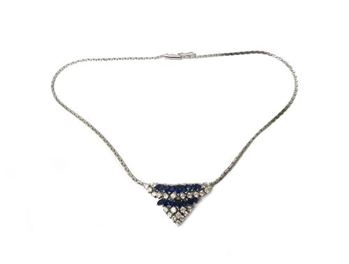 A sapphire and diamond necklace, the front in a curved triangular design, mounted with two rows of marquise shaped sapphires and otherwise mounted wit