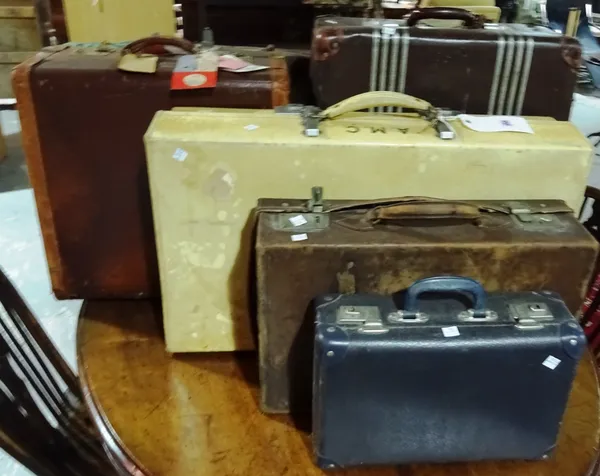 A group of seven suitcases of various shapes and sizes, including a Revelation pigskin yellow suitcase, four brown leather cases and two further. (7)