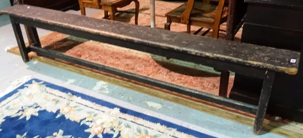 A 19th century painted pine bench, on trestle end supports united by a stretcher, 244cm long x 51cm high. K9