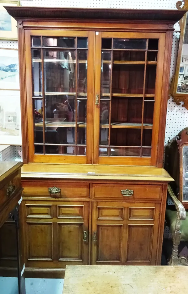 A Victorian walnut bookcase cabinet, with pair of glazed doors over a two drawer cupboard base, 134cm wide x 215cm high. C10