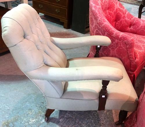 A late Victorian walnut framed low open armchair, with button back upholstery, on ring turned supports. E8