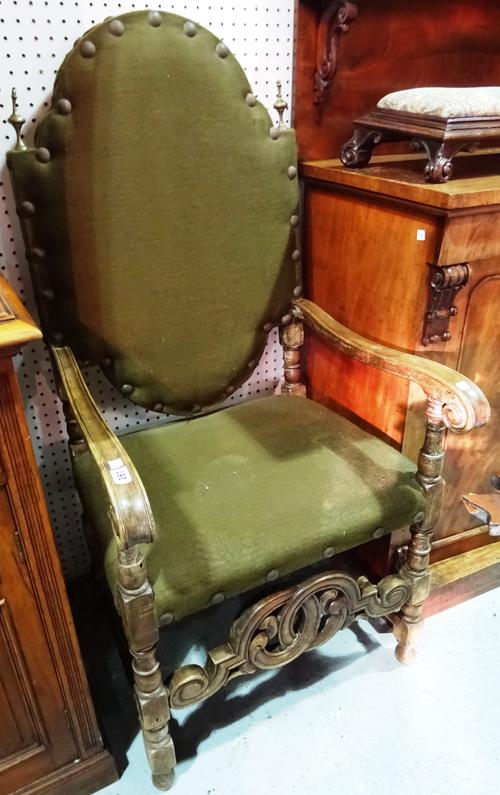 A 17th century style Spanish mahogany open armchair, with green upholstery. C10