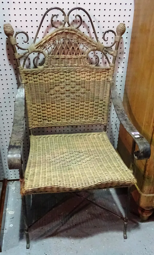 A 20th century wrought iron and cane open armchair. D10