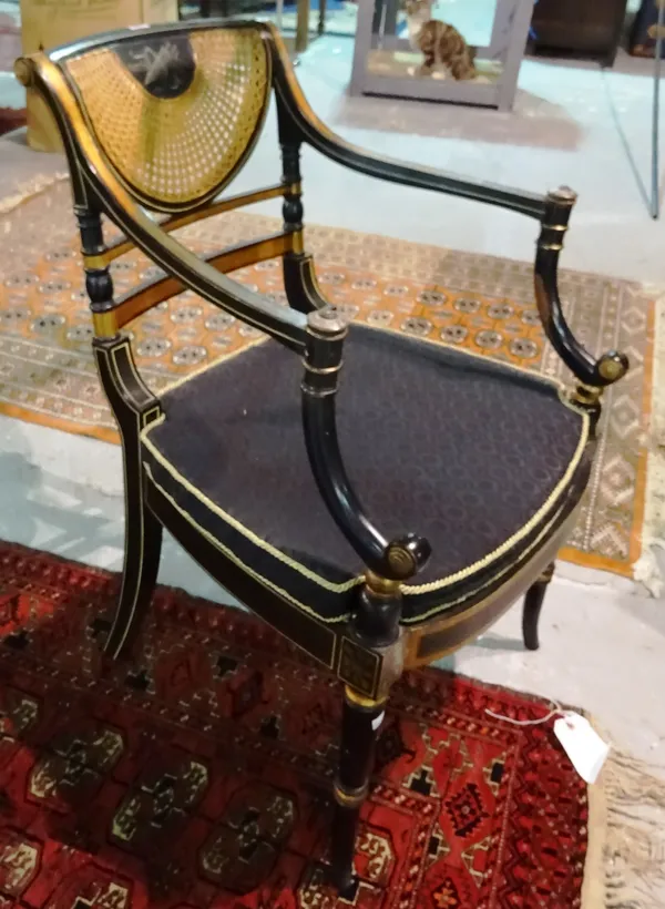 A Regency style ebonised fauteuil with cane back. G5
