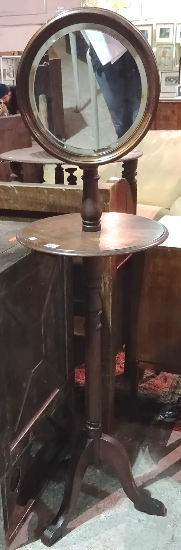 A Victorian mahogany floor standing mirror, with platform tier on a tripod base. J4