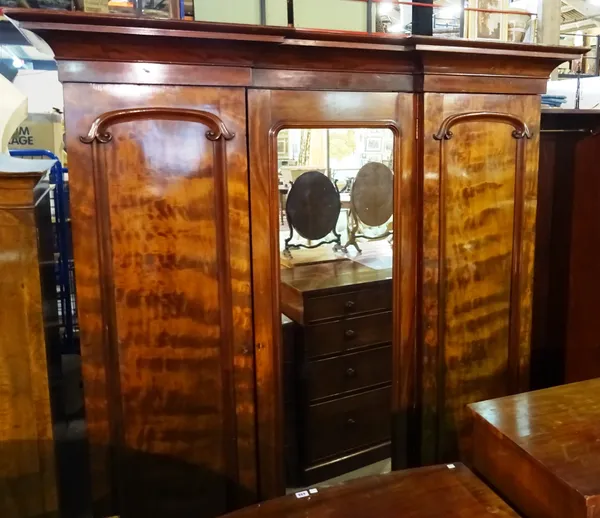 A Victorian triple door mahogany wardrobe with mirrored central door, 206cm wide x 217cm high. M8