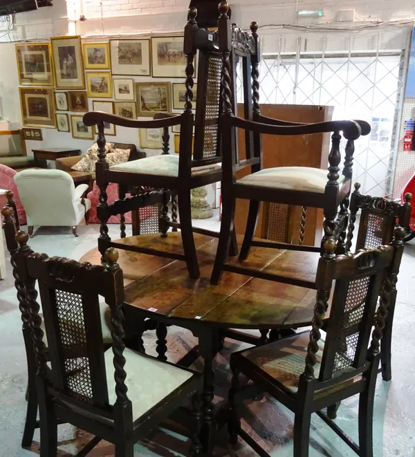 A set of eight mid 20th century oak and cane dining chairs with barley twist supports, (8).  C8