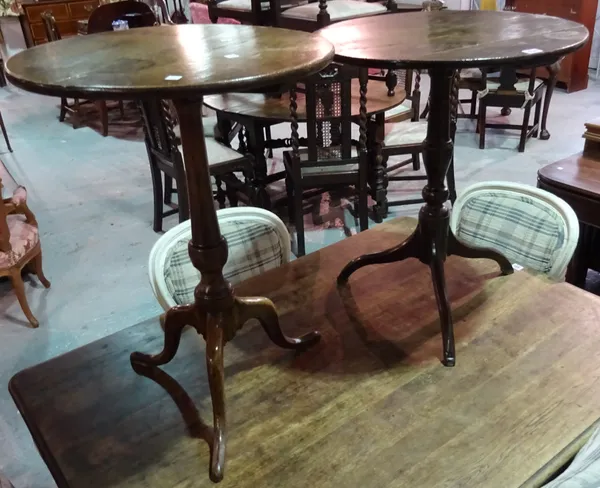 An 18th century oak tripod table and another similar, the larger 56cm wide, (2).  E9