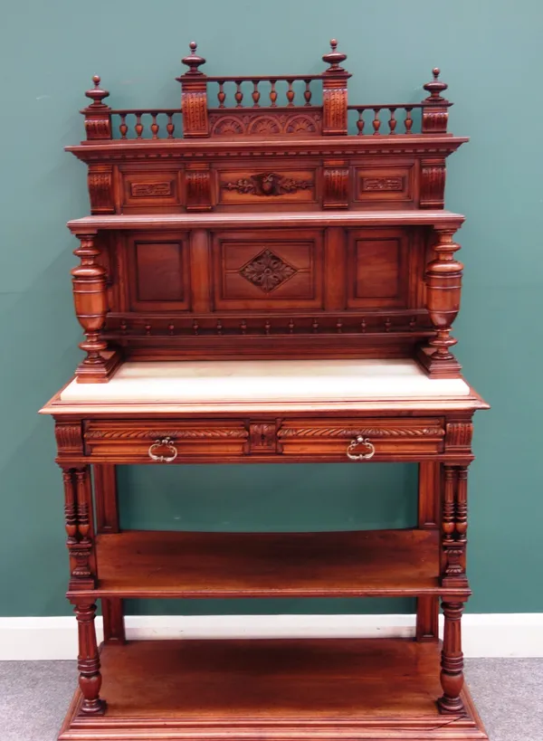 A 19th century French carved walnut and marble four tier buffet with a pair of frieze drawers and turned supports, 115cm wide x 194cm high x 47cm deep