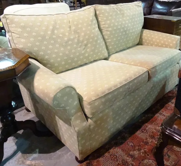 A 20th century sofa with grey patterned upholstery and roll-over arms on bun feet, 170cm wide x 77cm high x 86cm deep. F5