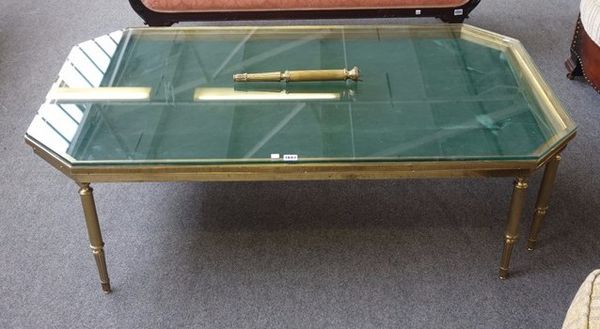 A mid-20th century lacquered brass coffee table, the canted rectangular glass inset top on eight reeded supports, 135cm wide x 40cm high.  H4