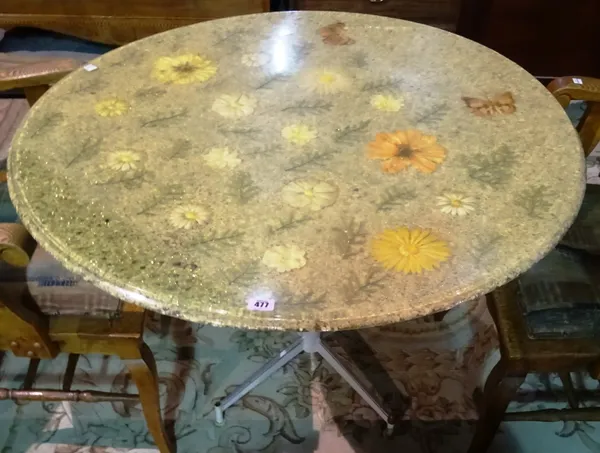 A 20th century circular resin topped kitchen table, with naturalistic decoration, on a metal base, 90cm wide x 75cm high. K9