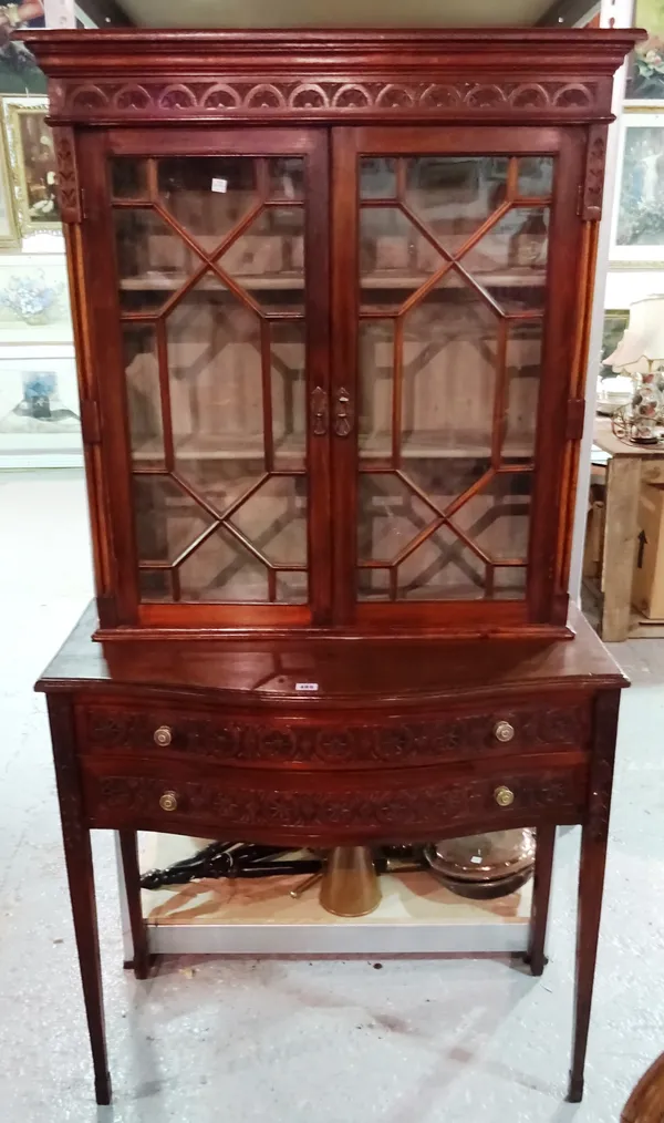 An Edwardian oak bookcase, with glazed top section over a two drawer base, 109cm wide.  S2