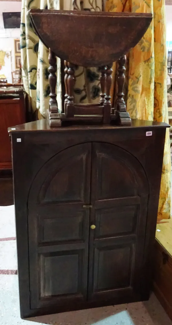 A stained pine corner cupboard, an oak single table, an oak twin dropleaf table, a Chinese tilt top trunk and an Edwardian walnut piano stool, (5).  J