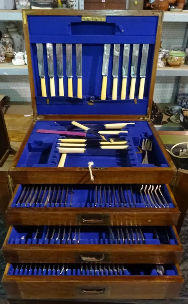 A large 20th century oak cased canteen box, containing a part set of silver plated flatware.  C5