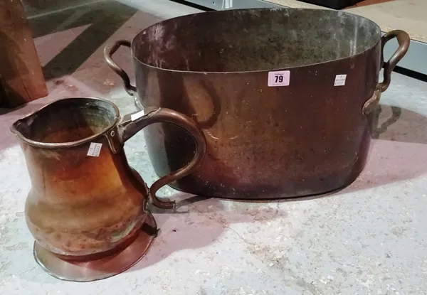 A large twin handled oval copper pot, and a copper jug, (2). K9