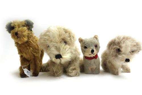 An Alpha Farnell musical toy dog, one similar smaller, and two straw filled toys, (4).