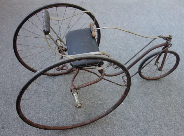 A Worthington Company metal three wheeled child size Velocipede, circa 1870 (with later alterations), the later spoked 27 inch wheels flanking a leath