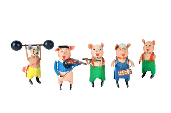 A Schuco three piece clockwork pig band, comprising; a drummer, a violinist and a pig with a flute, together with one further Schuco pig and a Schuco