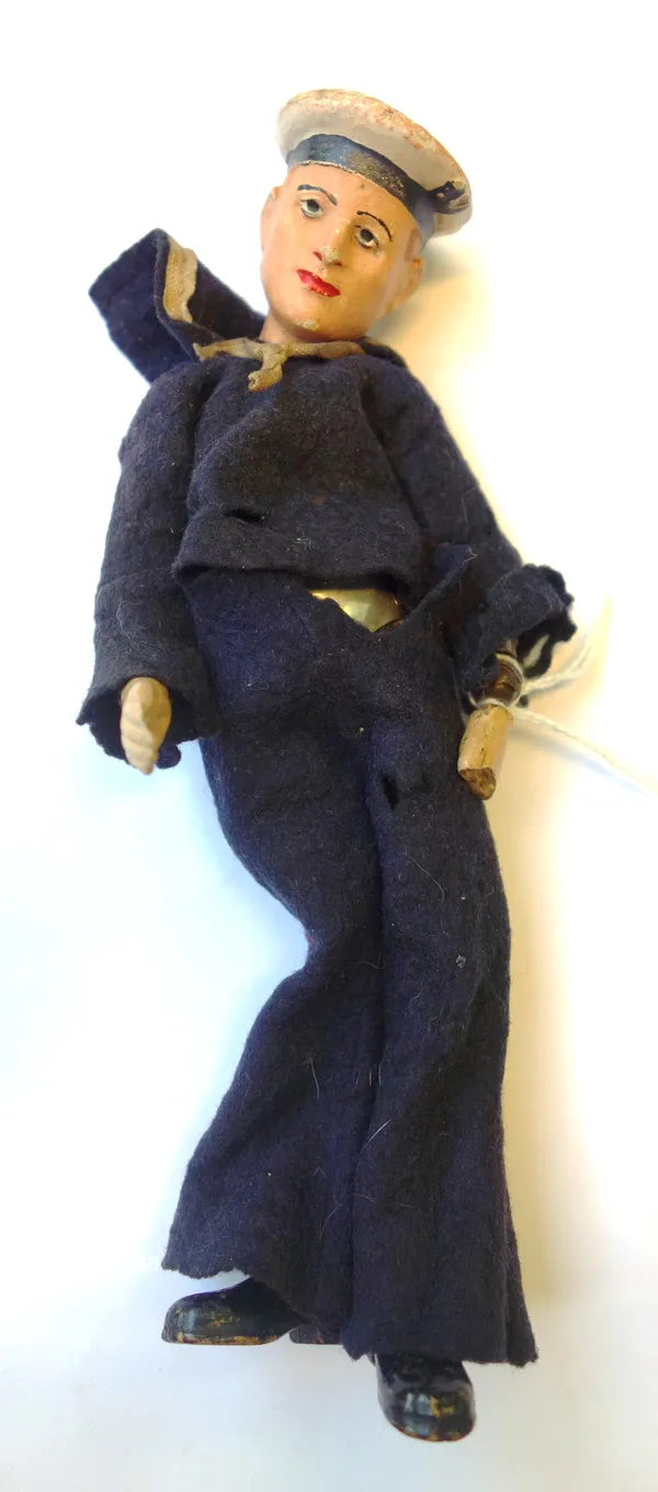 An unusual Swiss sailor doll, early/mid 20th century, with painted ceramic head and hands, and a ball and socket jointed metal body, stamped 'Made in