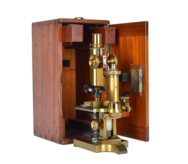 A Ross gilt brass microscope, late 19th century, with rack and pinion focusing and adjustable stage, in a fitted mahogany case, with accessories.  Ill