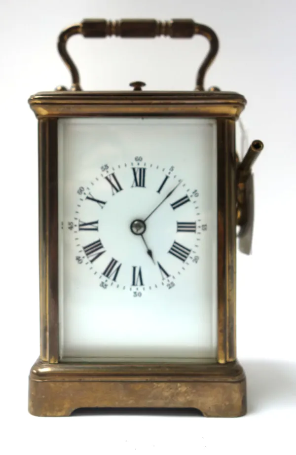 A French brass cased carriage clock, late 19th century, with visible escapement, push repeat, and white enamel dial with a two train movement, 12cm hi