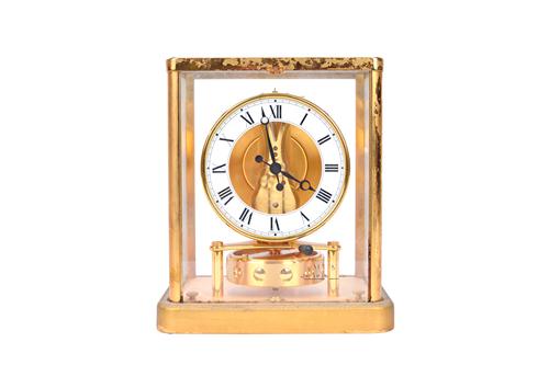 A Jaeger Le Coultre Atmos clock, 20th century, serial No.664967, in a rectangular glazed gilt brass case (a.f), 23cm high.  Illustrated