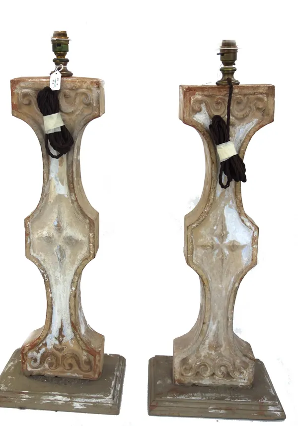 A pair of cream painted terracotta table lamps, early 20th century and later, of architectural distressed form, on painted wooden plinths with taperin