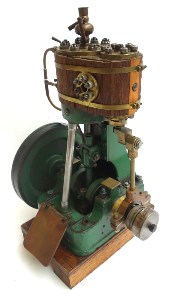 A scratch built vertical steam engine, early 20th century, with wooden clad boiler over a single piston and 7.5 inch fly wheel, on a wooden base, 41cm