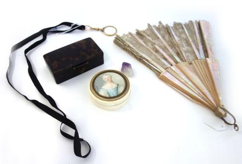 A 19th century ivory patch box and cover of circular form, the lid with a painted miniature on ivory of a lady in a blue frilled dressed, indistinctly
