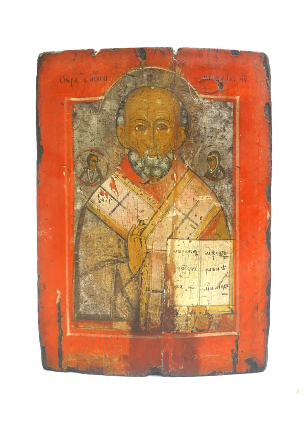 A 19th century Coptic icon, depicting Jesus Christ holding the bible, flanked by attendants, within a wide red border (a.f), 28cm x 20cm.