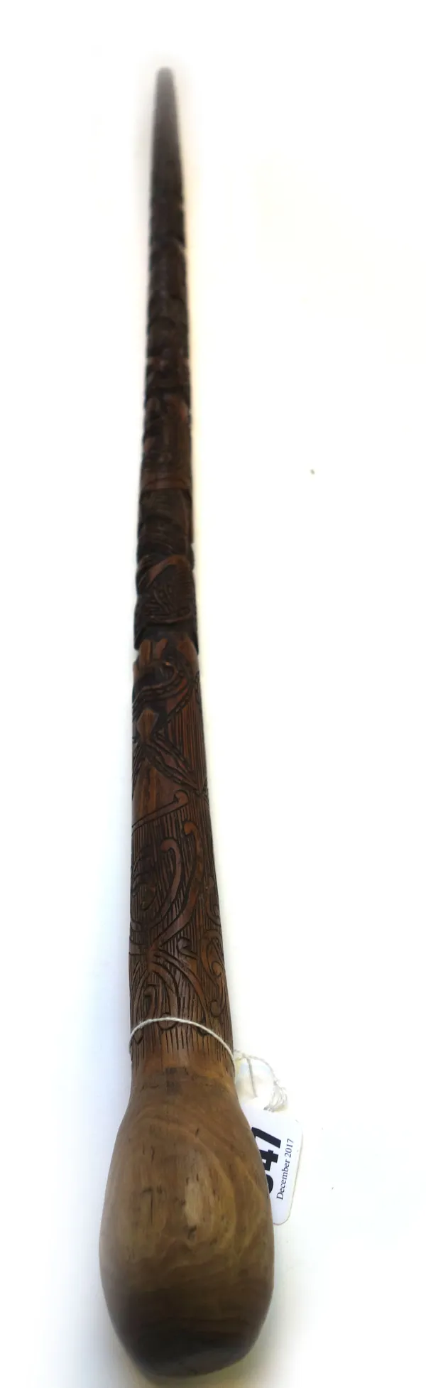 A Maori carved wooden walking stick, early 20th century, of tapering totem form, with a naturalistic bulbous pommel (90cm long) and an African gourd w
