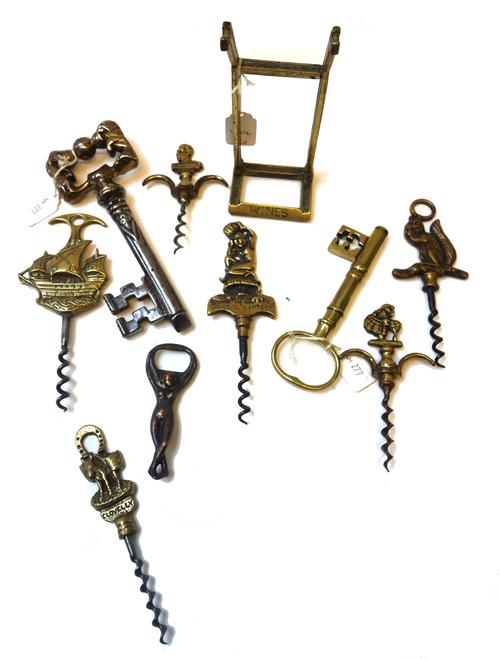 A collection of corkscrews, including two large 'keys', 18cm high, a 'King George' brass corkscrew and other novelty examples, (qty).