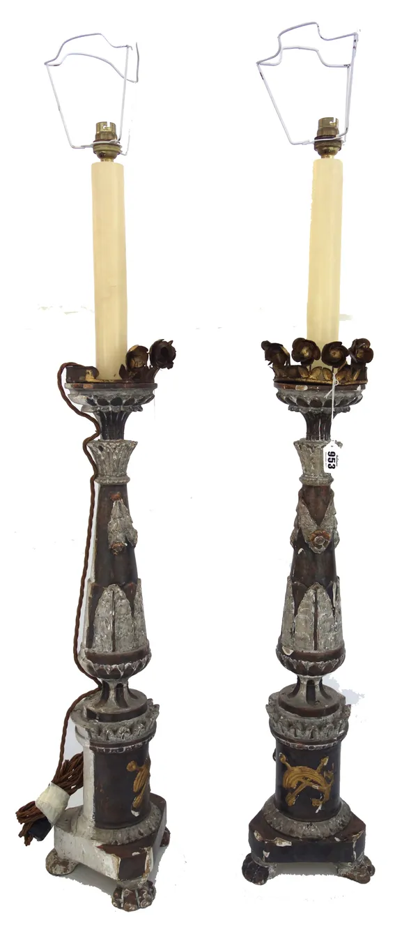 A pair of Italian painted and gilt pricket candlesticks, later adapted as lamp bases, 65cm high, extending fitments. (2)