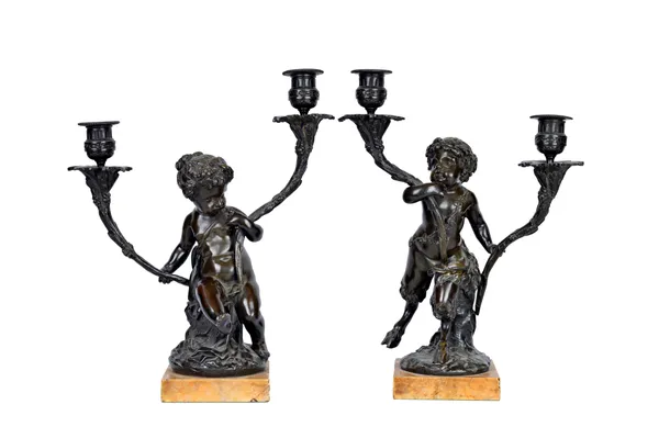 A pair of French bronze figural twin branch candelabra, 19th century, each putto of Satyr figure atop a Siena marble square plinth, 35cm high, (2).  I