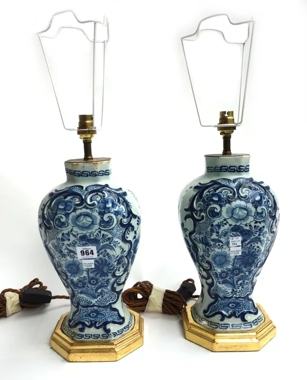 A pair of Dutch Delft tin glaze vases, converted to table lamps, circa 1740, each foliate decorated against a segmented baluster ground, the vases 29c