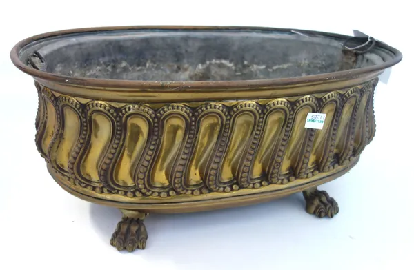 A Victorian brass jardiniere of oval fluted form, raised on four lion's paw feet and with a removable tin liner, 44.5cm wide, and a similar small bras