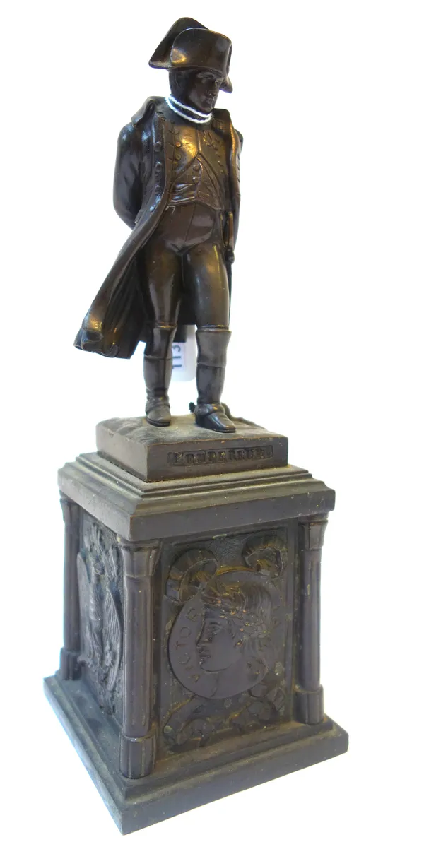 A Victorian bronze figure of Napoleon, titled and raised on a pillared rectangular plinth (21cm high), a pair of bronze figures, 19th century, each ca
