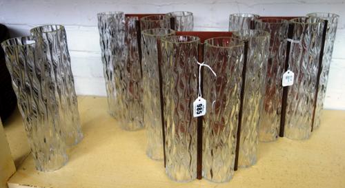 A set of three copper coloured metal and glass wall lights, 20th century, each of tubular form, with four spiral twist clear glass shades, 27.5cm high