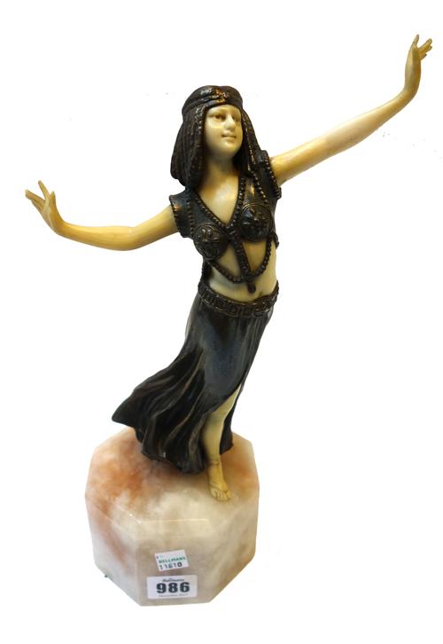 An Art Nouveau style patinated metal and faux ivory 'dancer', on an octagonal quartz base, (a.f), 32.5cm high.