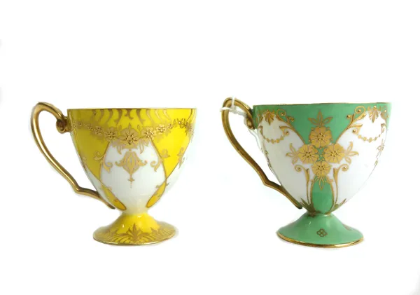 A Royal Worcester matched part service of gilt cabinet cups and saucers, circa 1934, green/ yellow with internal gilding and gilt foliate swags to the