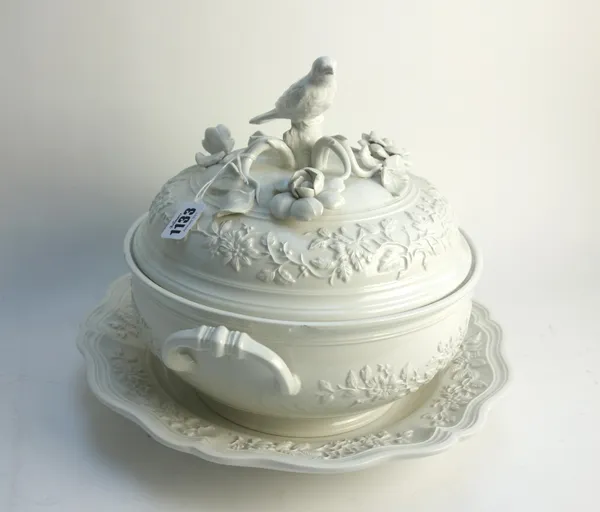 A modern French white glazed two-handled tureen, cover and stand of circular foliate moulded form with applied 'bird' handle to cover, printed mark to
