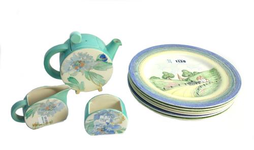 A set of six Clarice Cliff Bizarre 'Crayon' plates, each decorated with a paste/crayon scene (23cm diameter) and a Clarice Cliff style teapot, milk ju